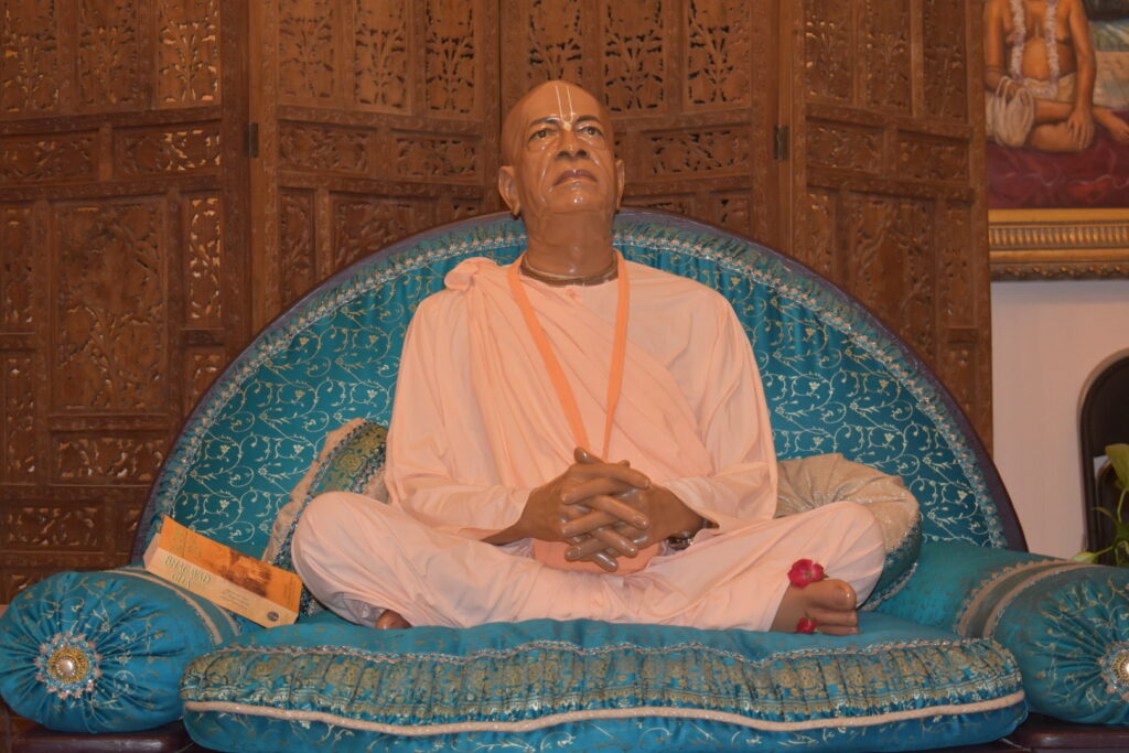 Srila Prabhupada seated on a blue vyasasana.