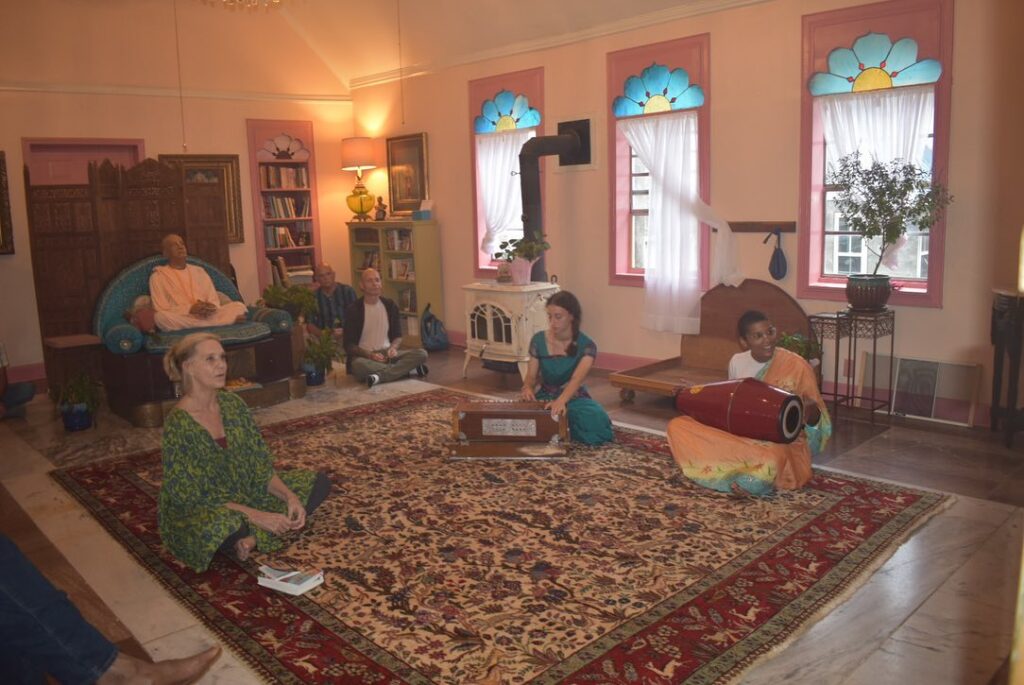 Kirtan with two ladies playing harmonium and mrdanga drum.